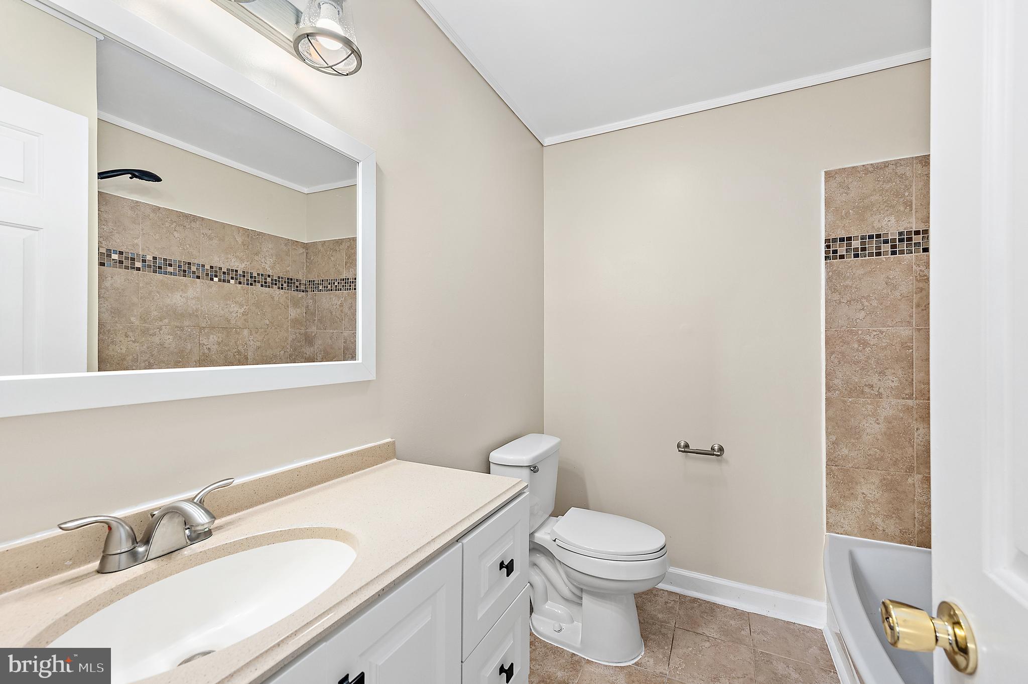 26792 Porter Mill Road Hebron, MD 21830 - Photo 26 of 91 a bathroom with a granite countertop sink mirror vanity and toilet