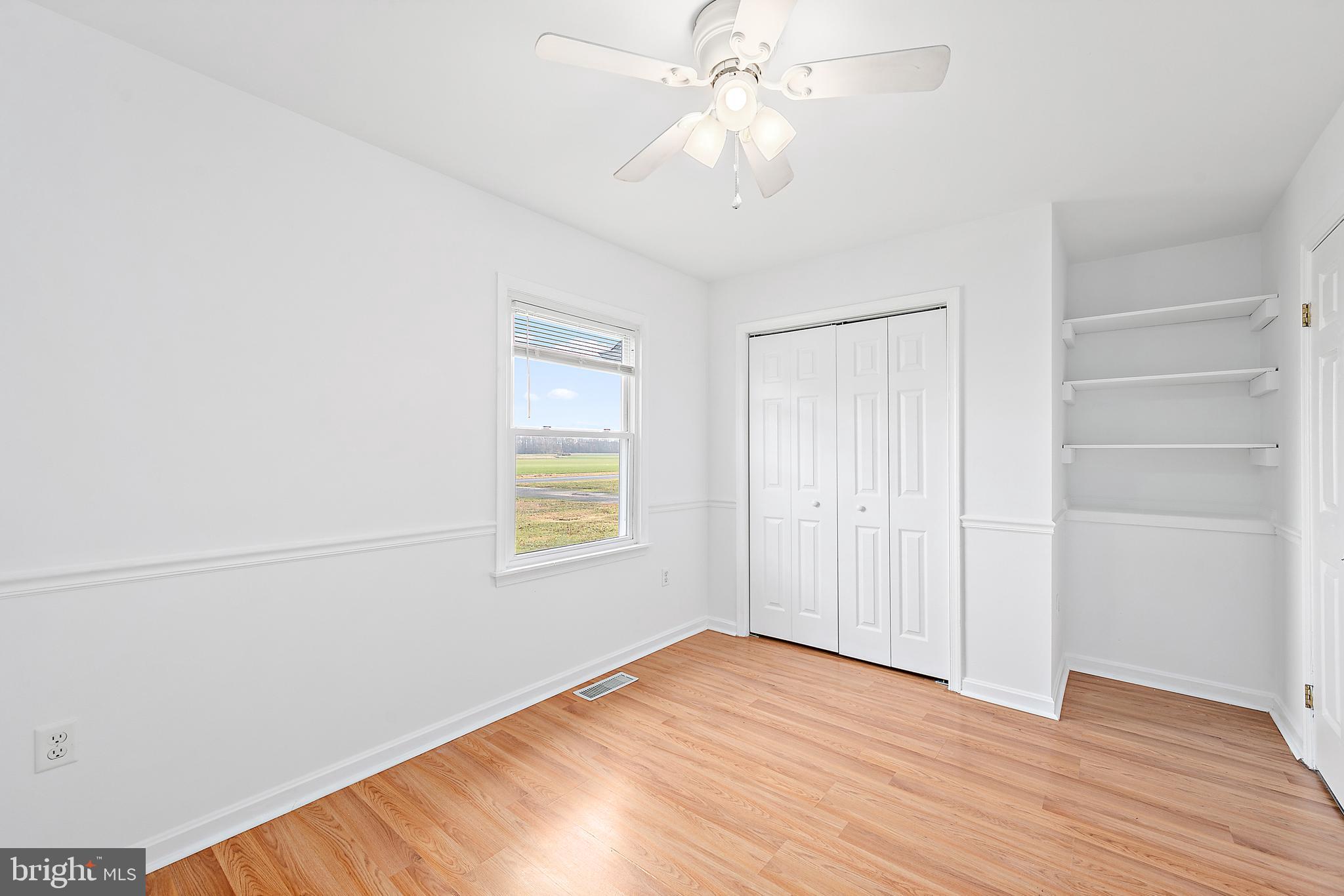 26792 Porter Mill Road Hebron, MD 21830 - Photo 31 of 91 an empty room with wooden floor closet and windows