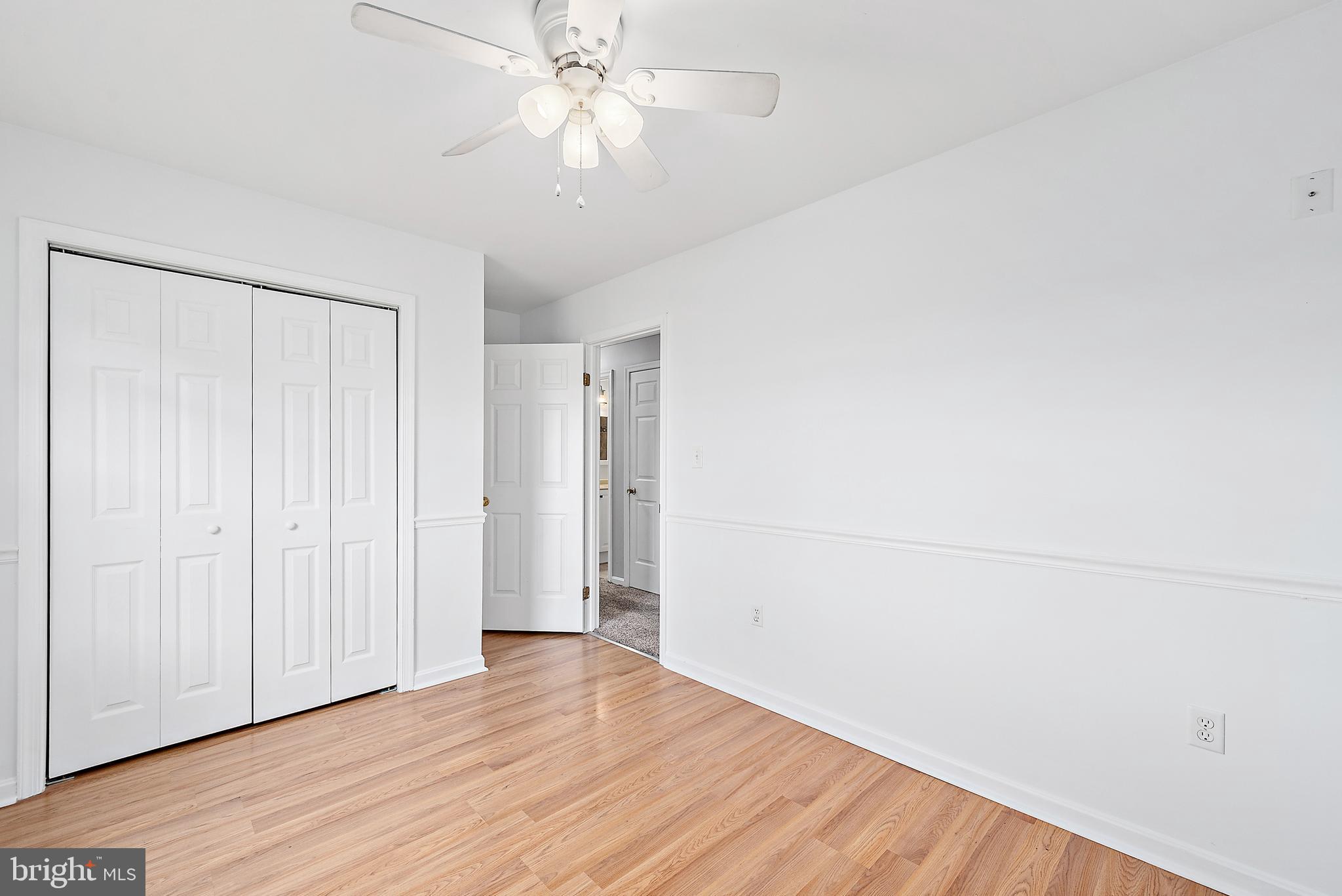 26792 Porter Mill Road Hebron, MD 21830 - Photo 32 of 91 an empty room with wooden floor and fan