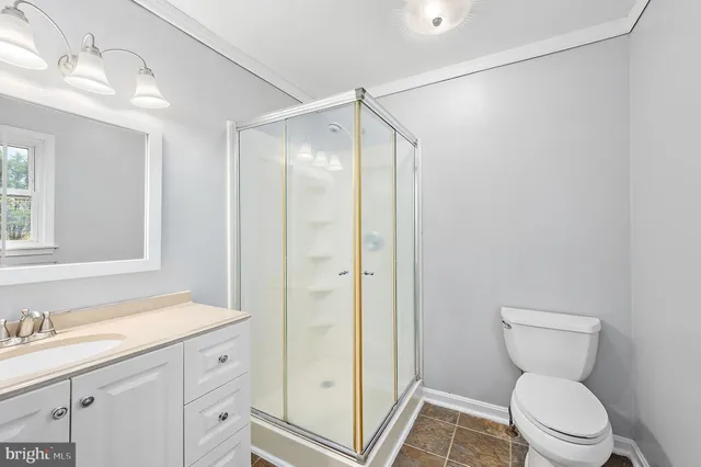 a front view of a house with a garden and yard