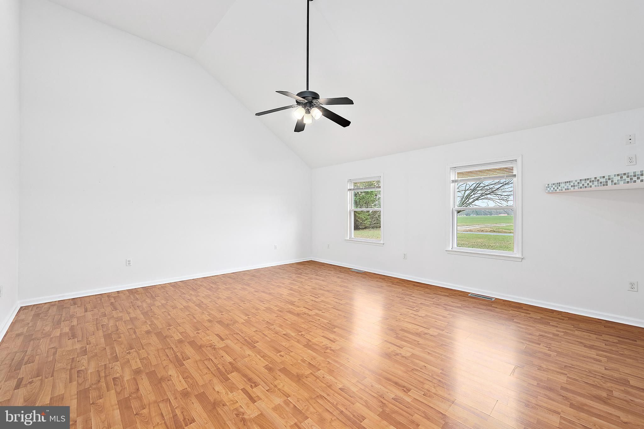 26792 Porter Mill Road Hebron, MD 21830 - Photo 41 of 91 an empty room with wooden floor ceiling fan and windows