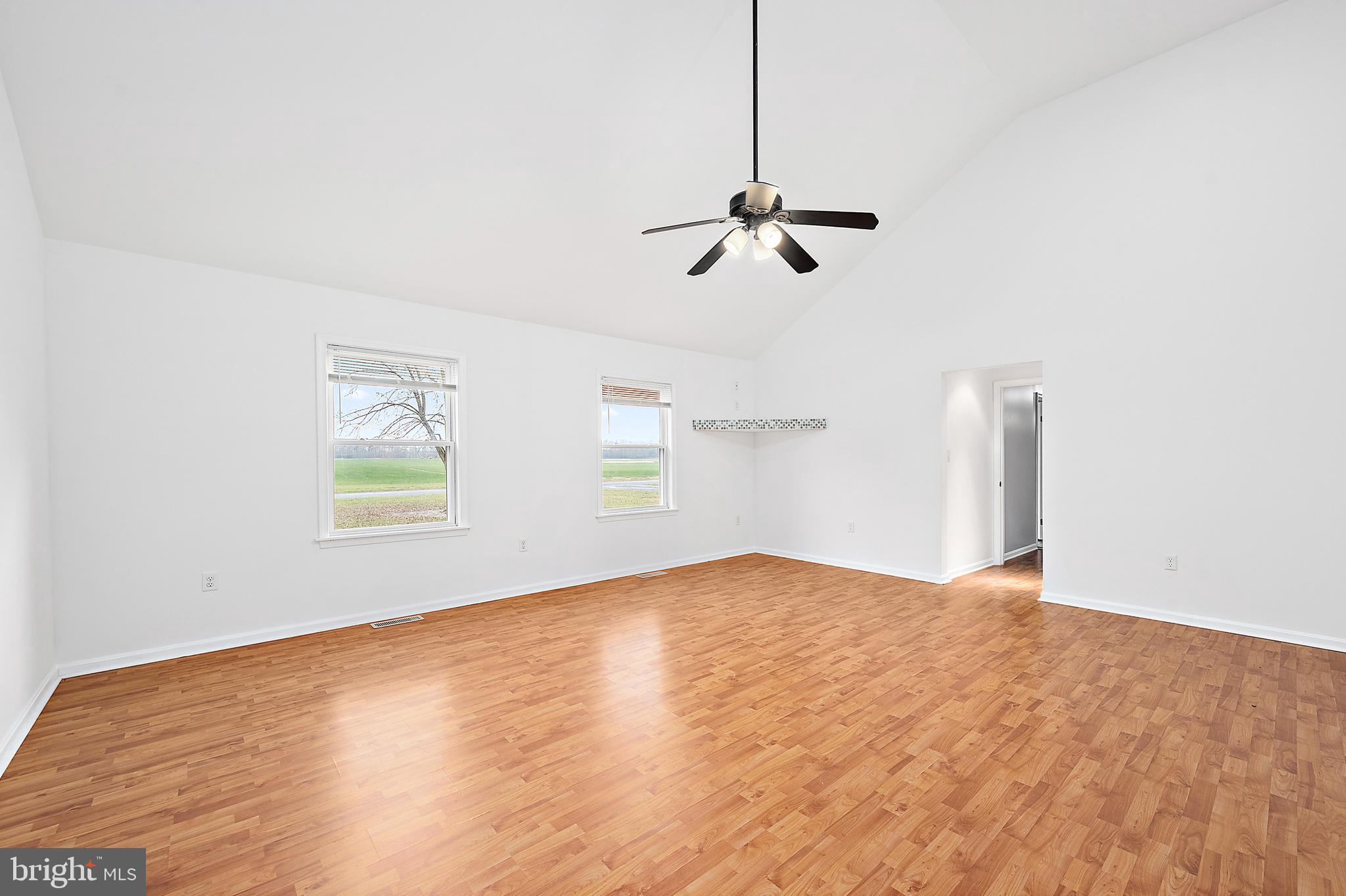 26792 Porter Mill Road Hebron, MD 21830 - Photo 42 of 91 a view of empty room with wooden floor and ceiling fan