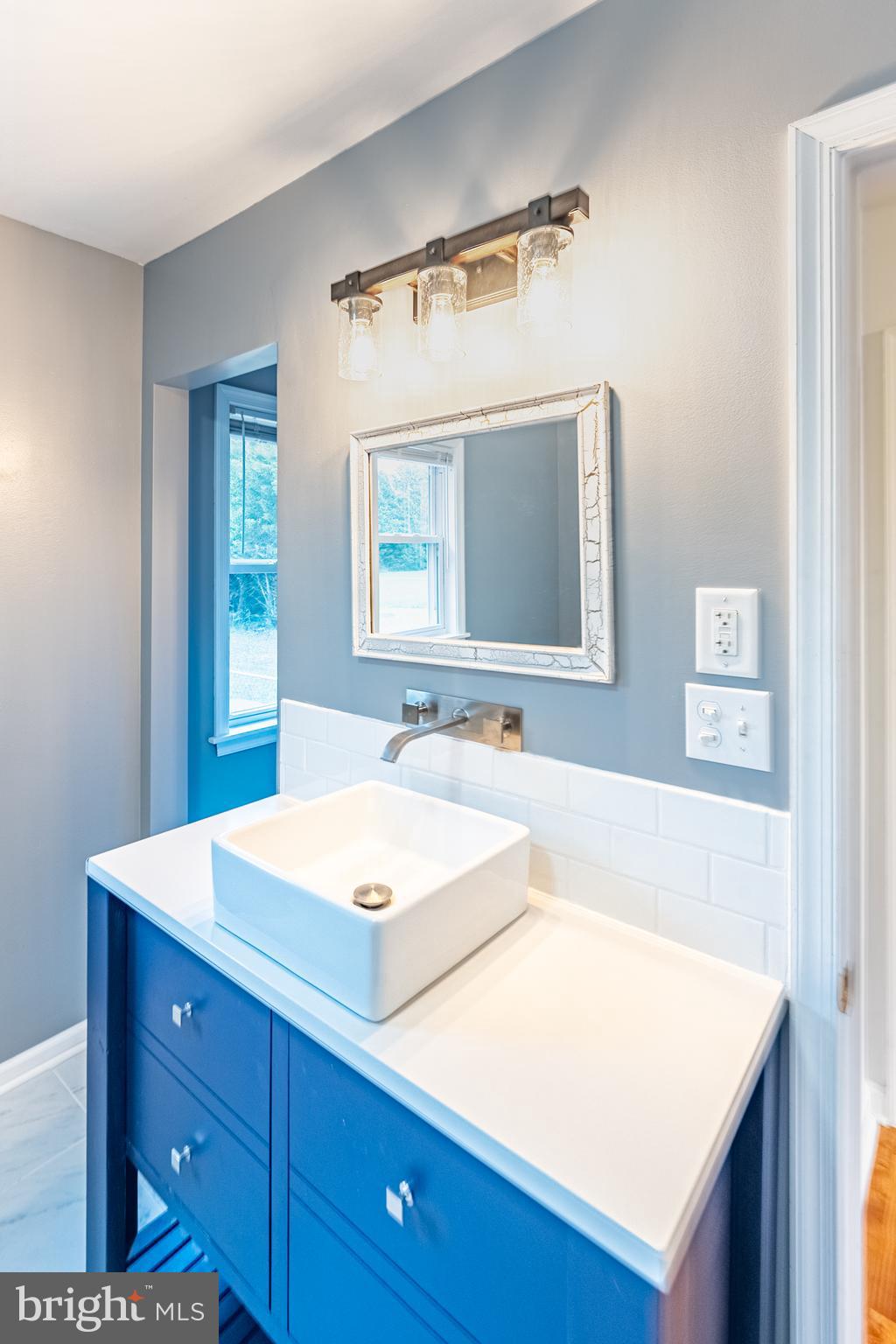 26792 Porter Mill Road Hebron, MD 21830 - Photo 49 of 91 a bathroom with a sink and a mirror