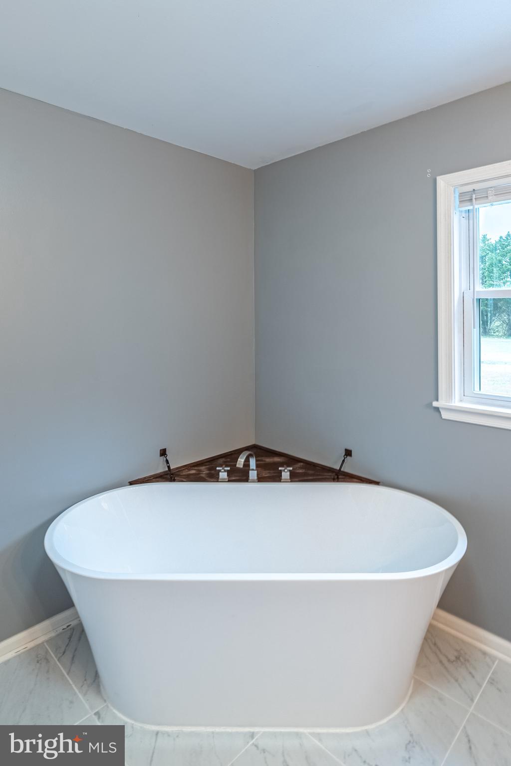 26792 Porter Mill Road Hebron, MD 21830 - Photo 51 of 91 a white bath tub sitting in a bathroom