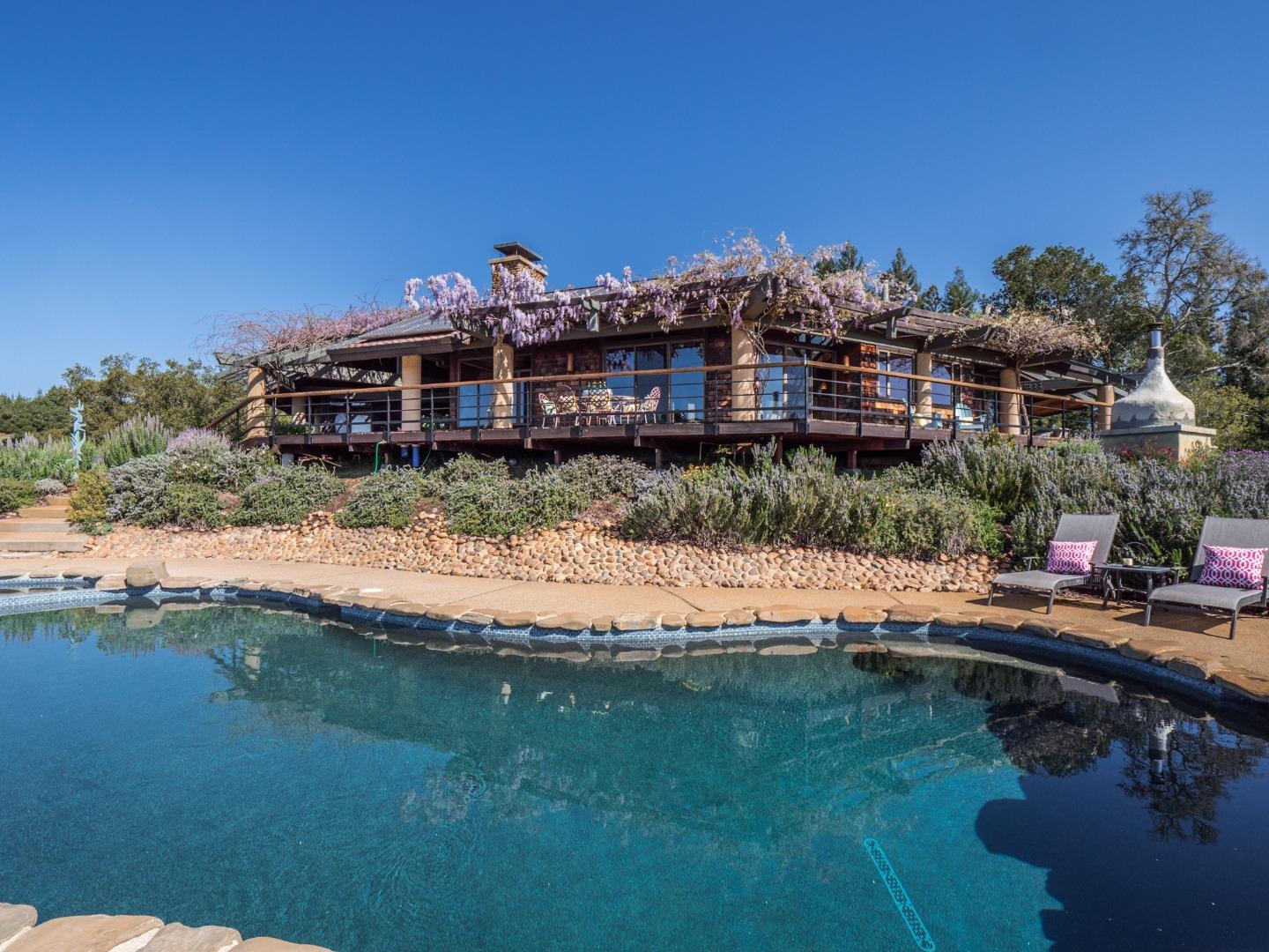 a aerial view of a house with a yard lake view and mountain view