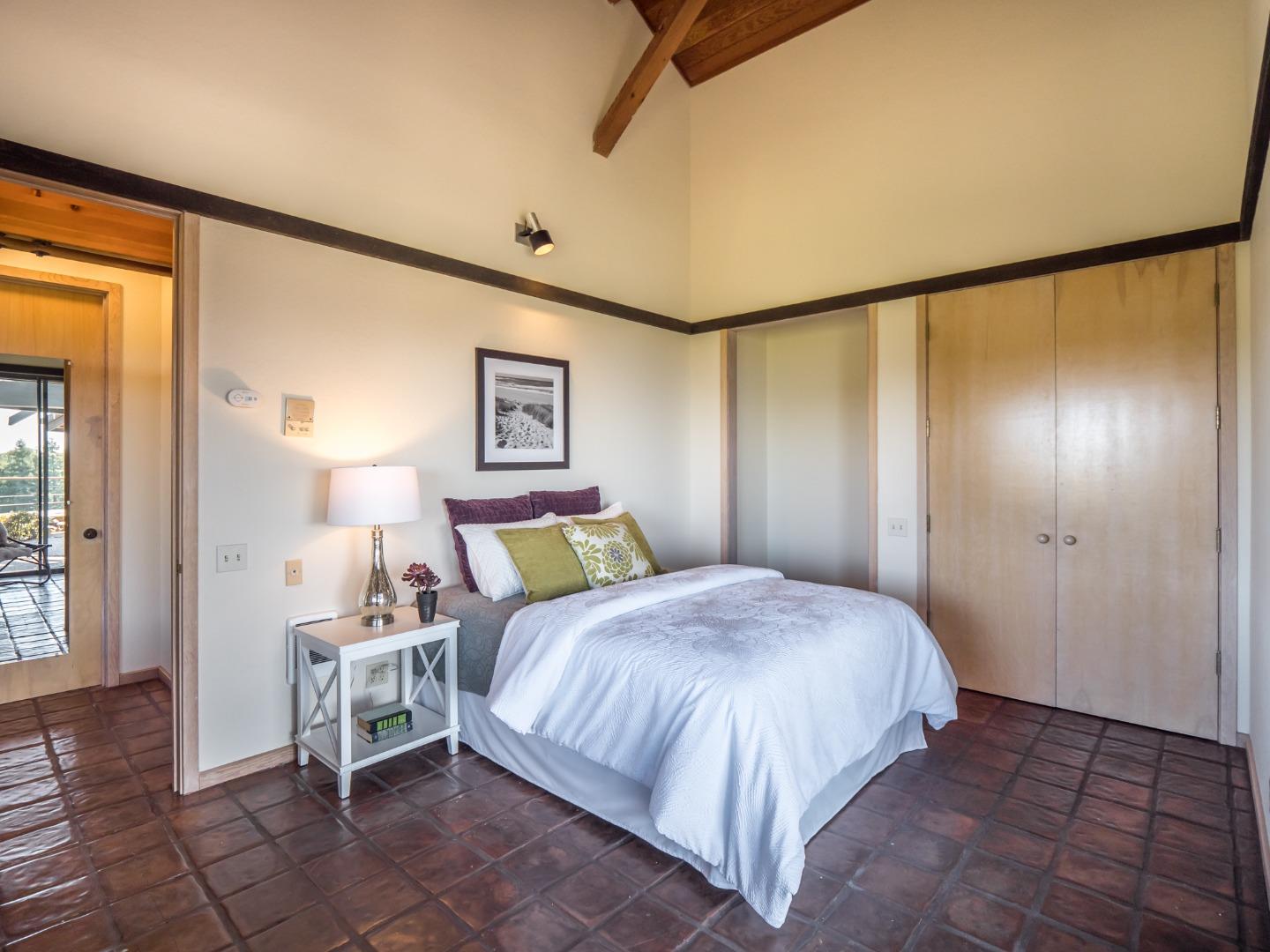 895 Rider Ridge Road Santa Cruz, CA 95065 - Photo 38 of 46 a bedroom with a bed lamps and a mirror