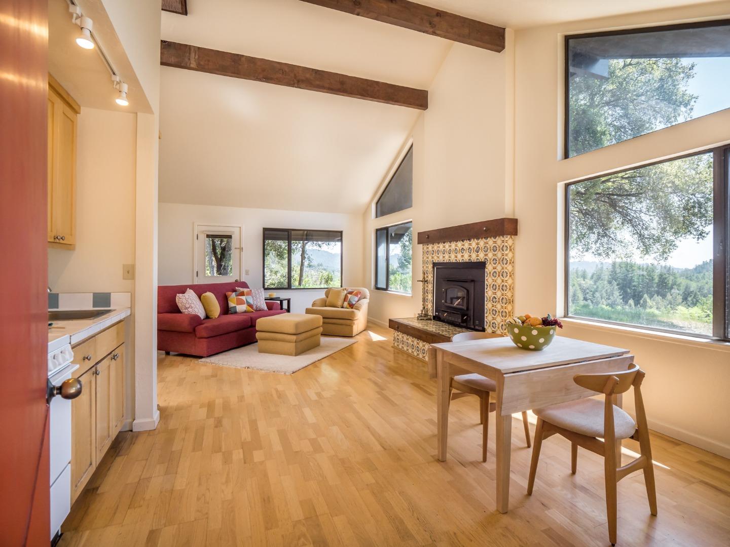 895 Rider Ridge Road Santa Cruz, CA 95065 - Photo 43 of 46 a living room with furniture a fireplace and a floor to ceiling window