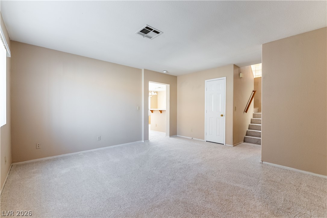 2657 Storey Circle Henderson, NV 89074 - Photo 2 of 12 This inviting living space features soft carpeting and convenient access to other areas of the home.