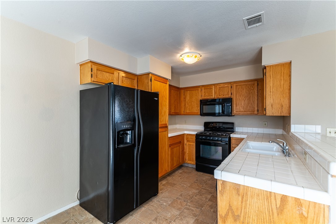 2657 Storey Circle Henderson, NV 89074 - Photo 3 of 12 This functional kitchen features ample cabinetry and a practical layout for everyday living.