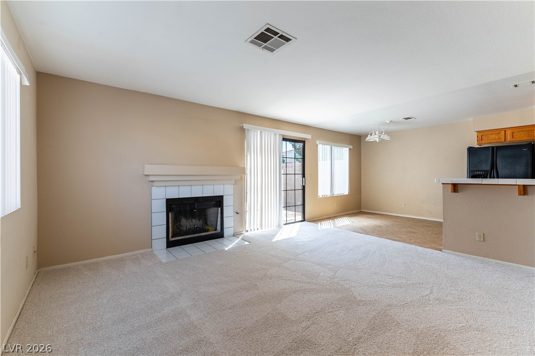 2657 Storey Circle Henderson, NV 89074 - Photo 6 of 12 This bright living area features a cozy fireplace and convenient sliding glass door access.