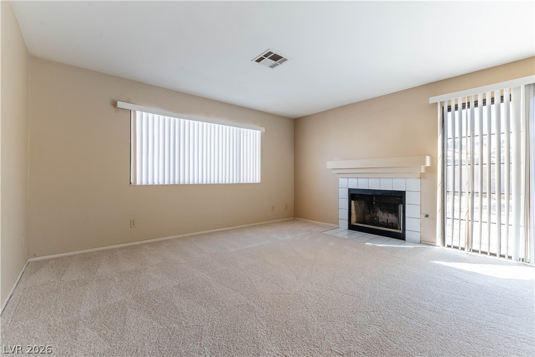 2657 Storey Circle Henderson, NV 89074 - Photo 7 of 12 This living room features a cozy fireplace, perfect for creating a comfortable atmosphere.