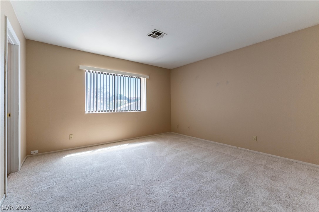 2657 Storey Circle Henderson, NV 89074 - Photo 10 of 12 This spacious bedroom offers ample natural light and plush carpeting, ready for your personal touch.