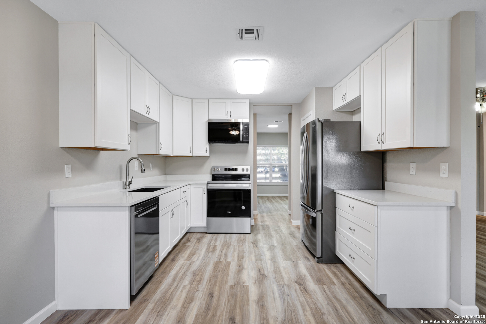 7103 Spring Point Street San Antonio, TX 78249 - Photo 15 of 28 a kitchen with stainless steel appliances a refrigerator stove top oven and sink