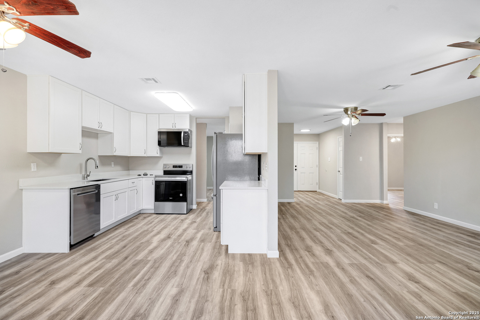 7103 Spring Point Street San Antonio, TX 78249 - Photo 24 of 28 a view of a kitchen with wooden floor and a kitchen