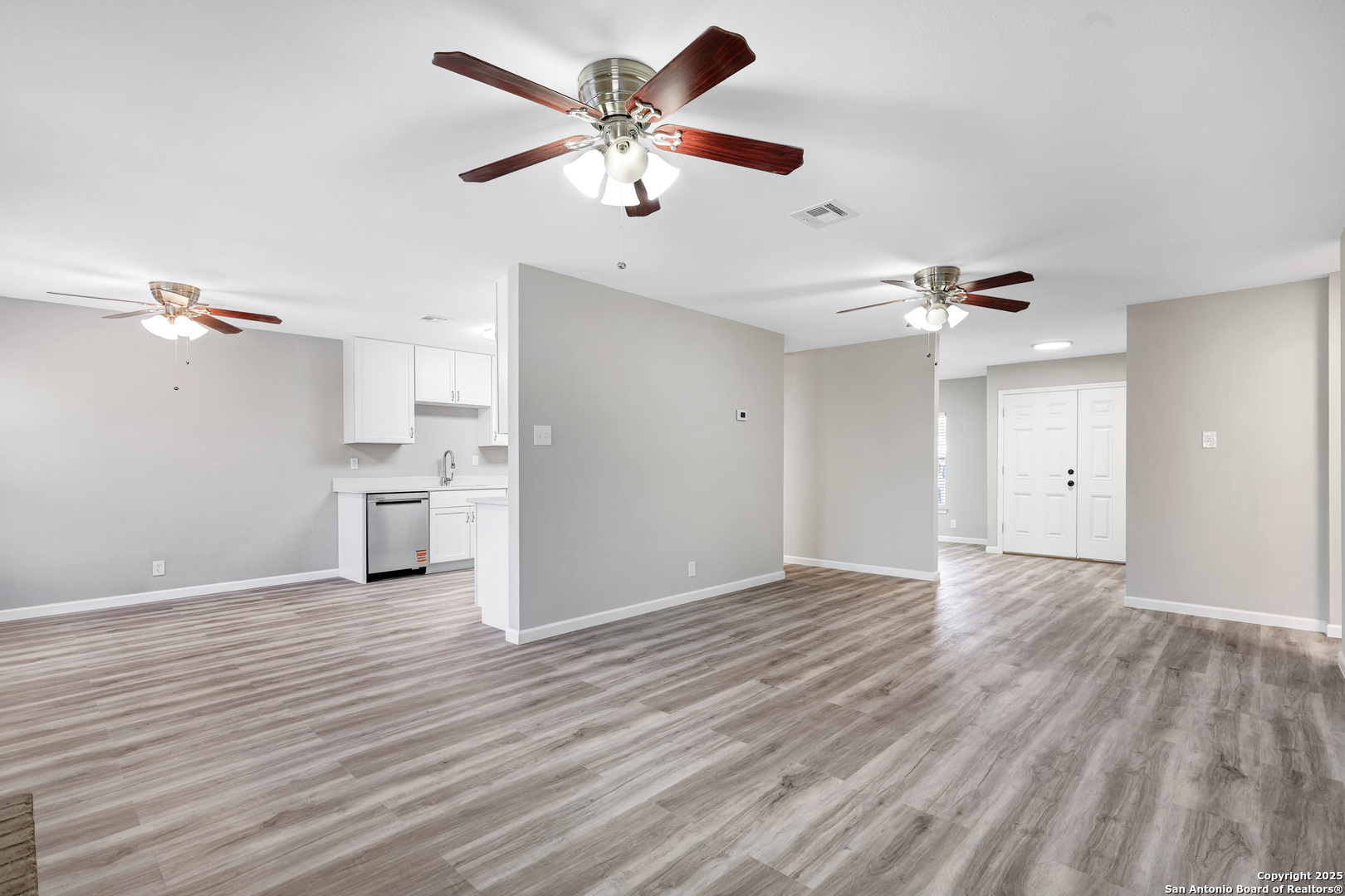 7103 Spring Point Street San Antonio, TX 78249 - Photo 4 of 28 a view of a kitchen with a dishwasher cabinet and a fireplace
