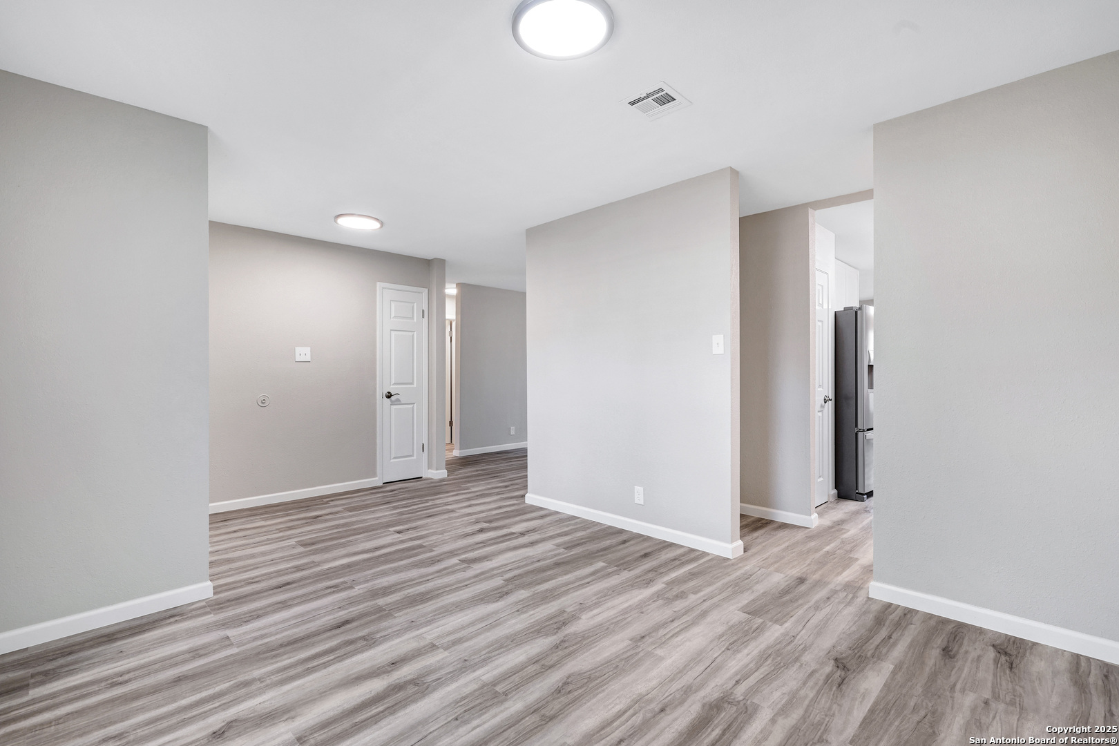 7103 Spring Point Street San Antonio, TX 78249 - Photo 7 of 28 a view of an empty room with wooden floor