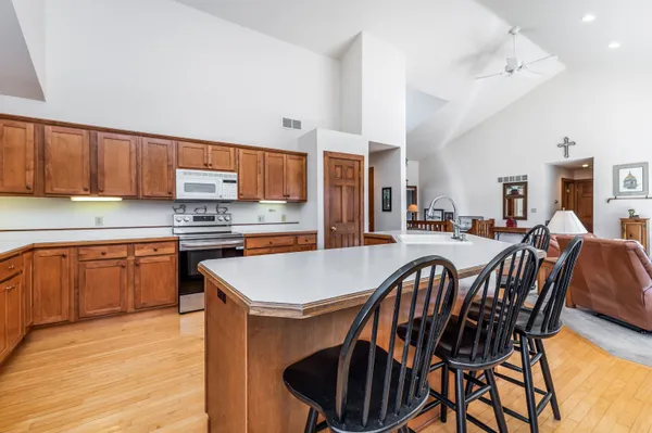a spacious bedroom with a large bed and a chandelier