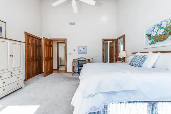 a spacious bathroom with a tub sink and mirror