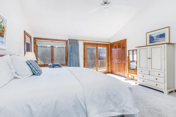 a bedroom with a bed and a large window