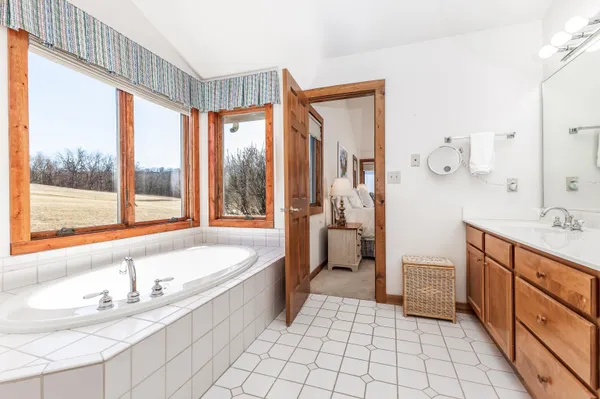 a bedroom with two beds and a lamp