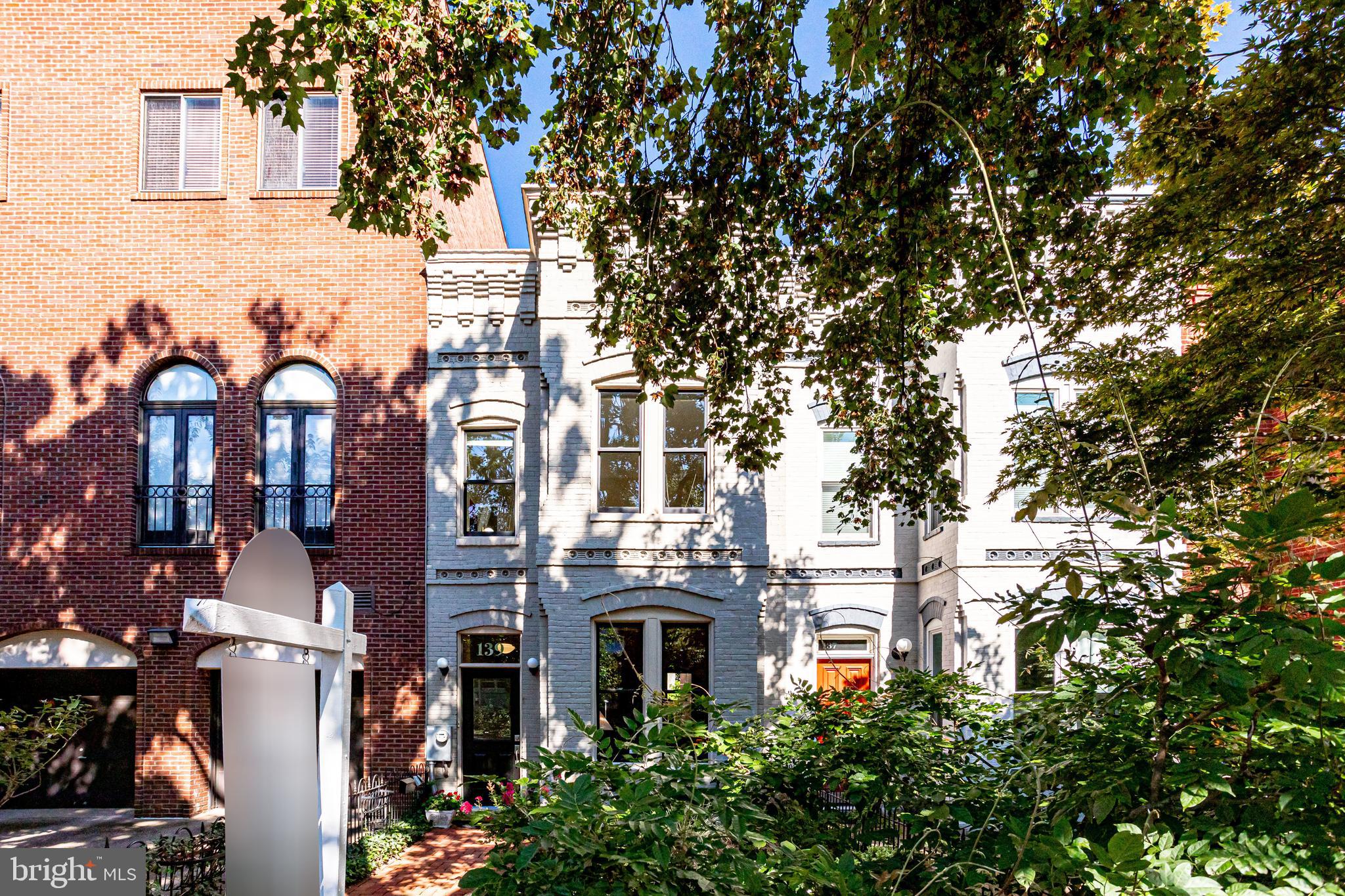 a front view of a building with a tree