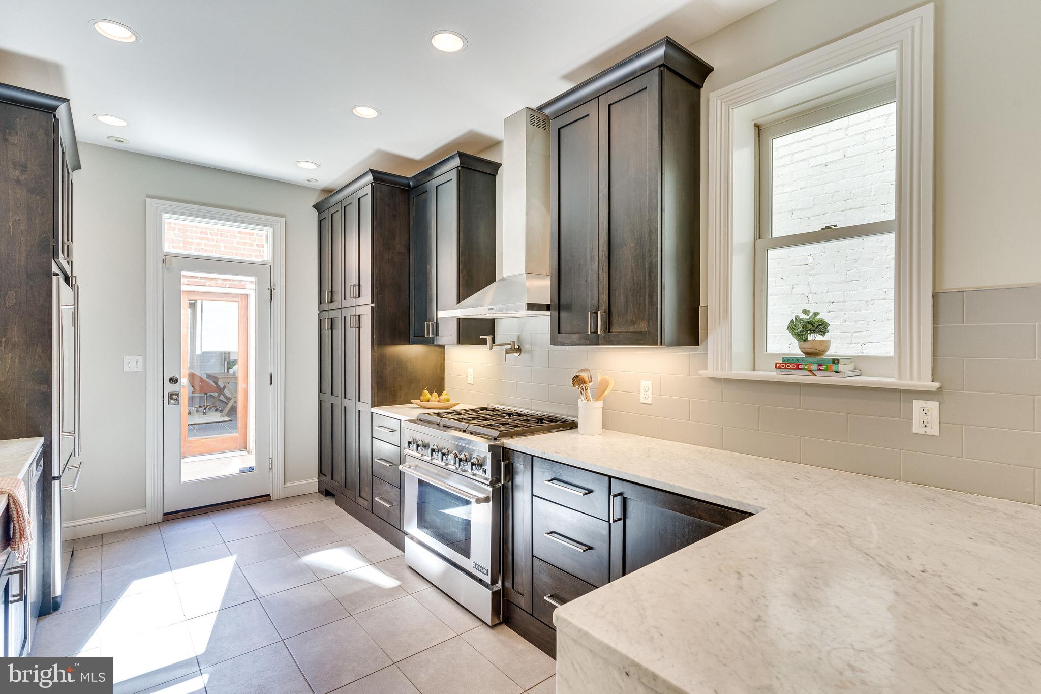 139 12th Street Northeast Washington, DC 20002 - Photo 15 of 50 a kitchen with a stove a sink and a refrigerator