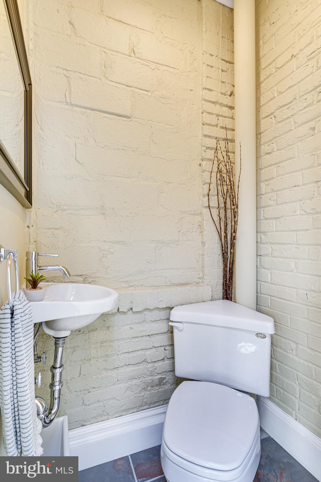 139 12th Street Northeast Washington, DC 20002 - Photo 26 of 50 a white toilet sitting next to a bathroom sink
