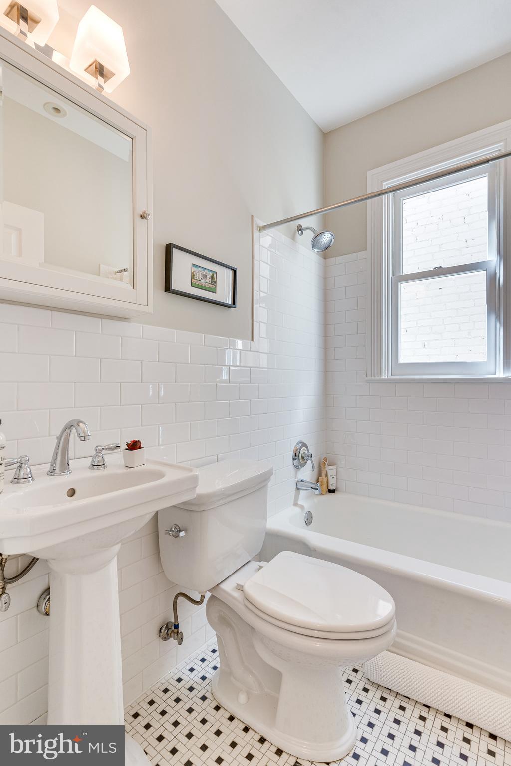 139 12th Street Northeast Washington, DC 20002 - Photo 46 of 50 a bathroom with a sink a toilet and shower