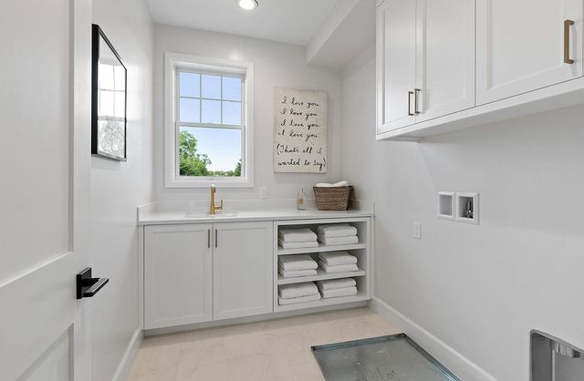 a view of cabinets a sink and a window in a room