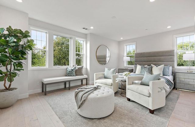a living room with furniture and a large mirror