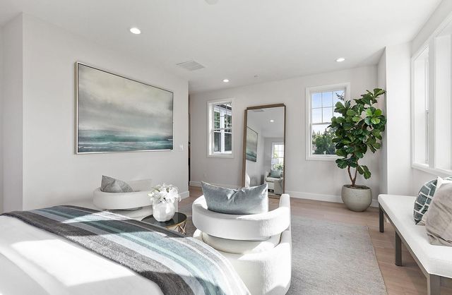 a bathroom with a double vanity sink a mirror and a bathtub