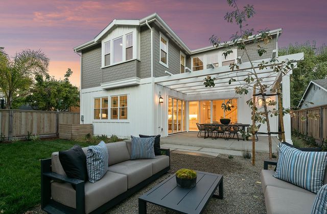 a view of a patio with table and chairs and wooden floor