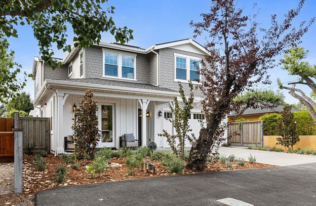 front view of a house with a tree