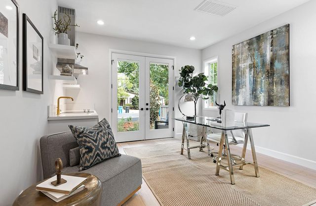 a living room with furniture and a potted plant