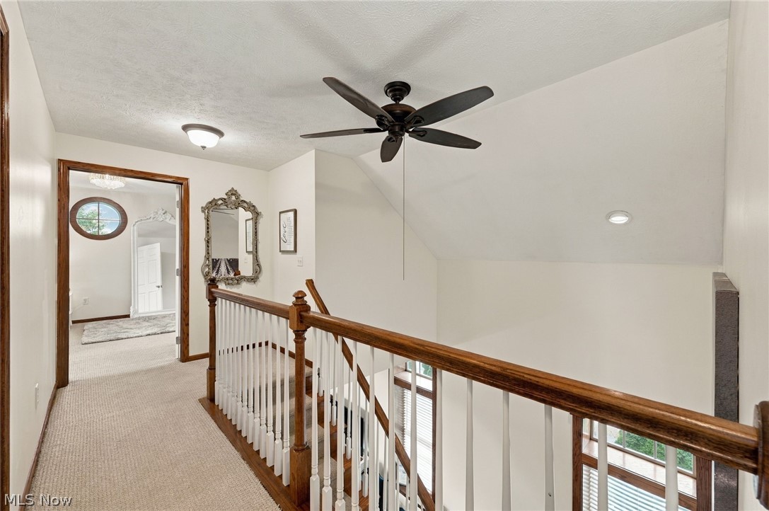42764 Russia Road Elyria, OH 44035 - Photo 27 of 50 Carpeted hallway featuring a ceiling fan, recessed lighting, and wood-finish handrail with white balusters