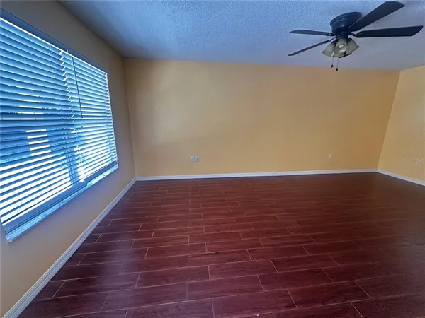 a view of room with window and wooden floor