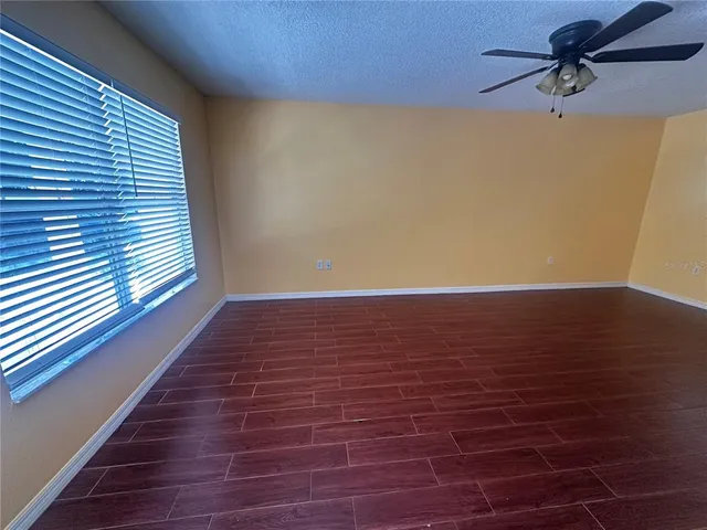 a view of room with window and wooden floor