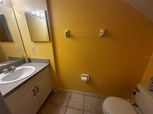a bathroom with a sink mirror vanity and toilet