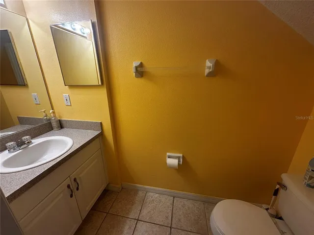 a bathroom with a sink mirror vanity and toilet
