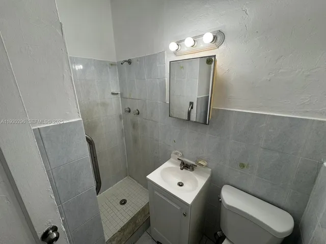 a bathroom with a toilet sink and shower