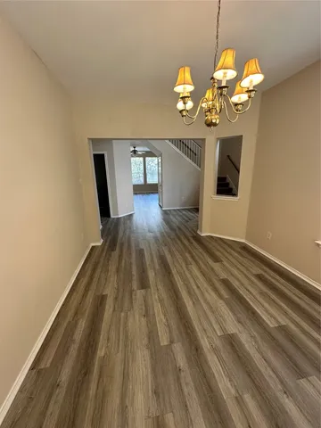 a view of a room with wooden floor and staircase