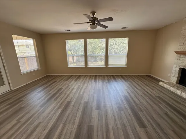 wooden floor in an empty room with a window
