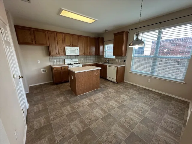 a kitchen with a stove a sink and a refrigerator