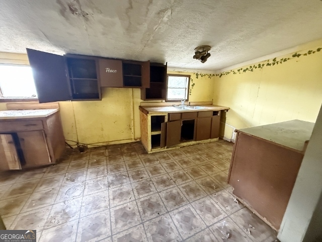 150 Kemp Road Swainsboro, GA 30401 - Photo 6 of 18 a view of kitchen with refrigerator stove and wooden cabinets