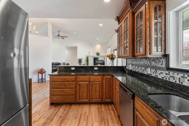 a kitchen with sink a refrigerator and cabinets