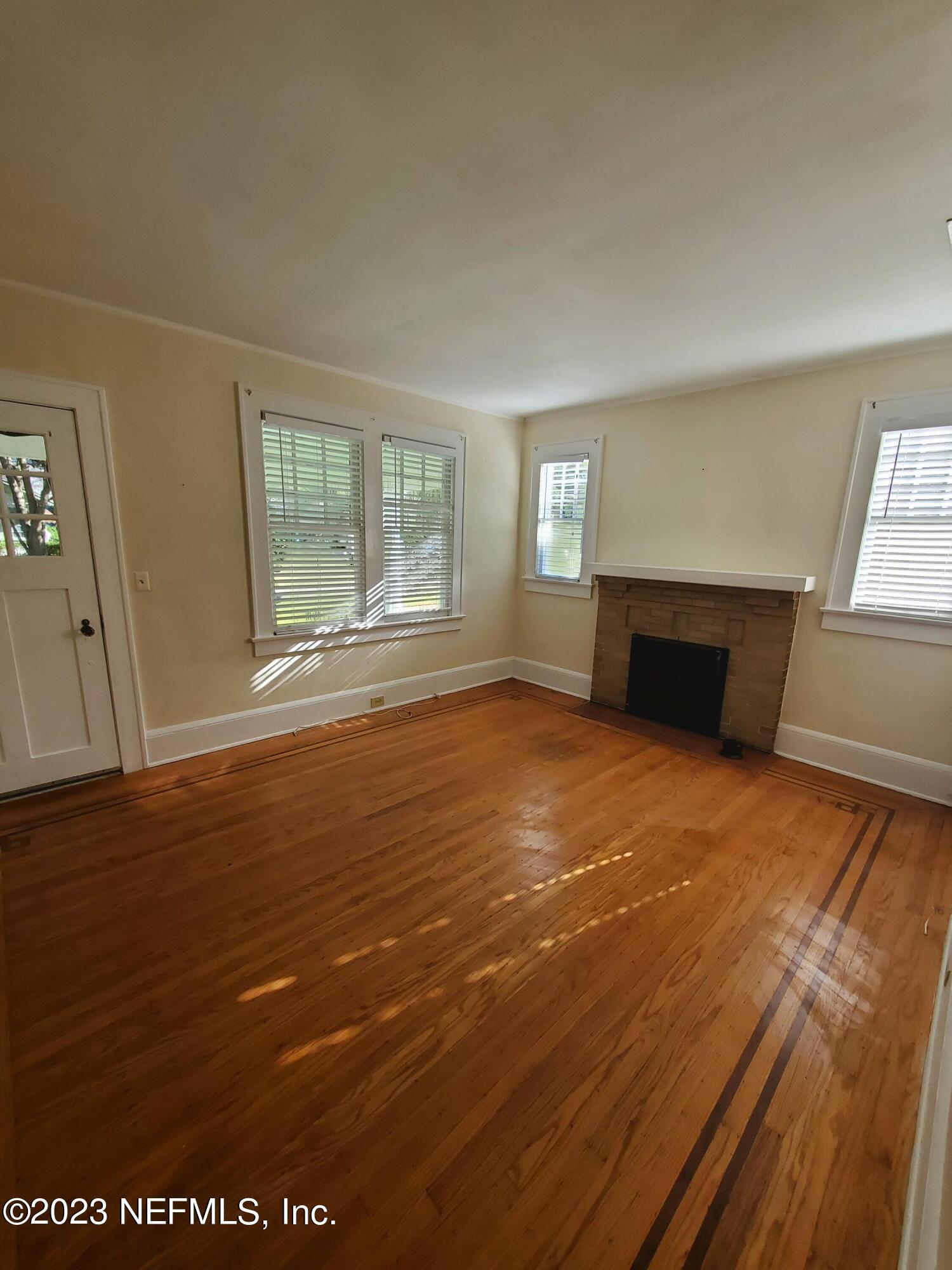 1450 Talbot Avenue Jacksonville, FL 32205 - Photo 6 of 21 an empty room with wooden floor and windows