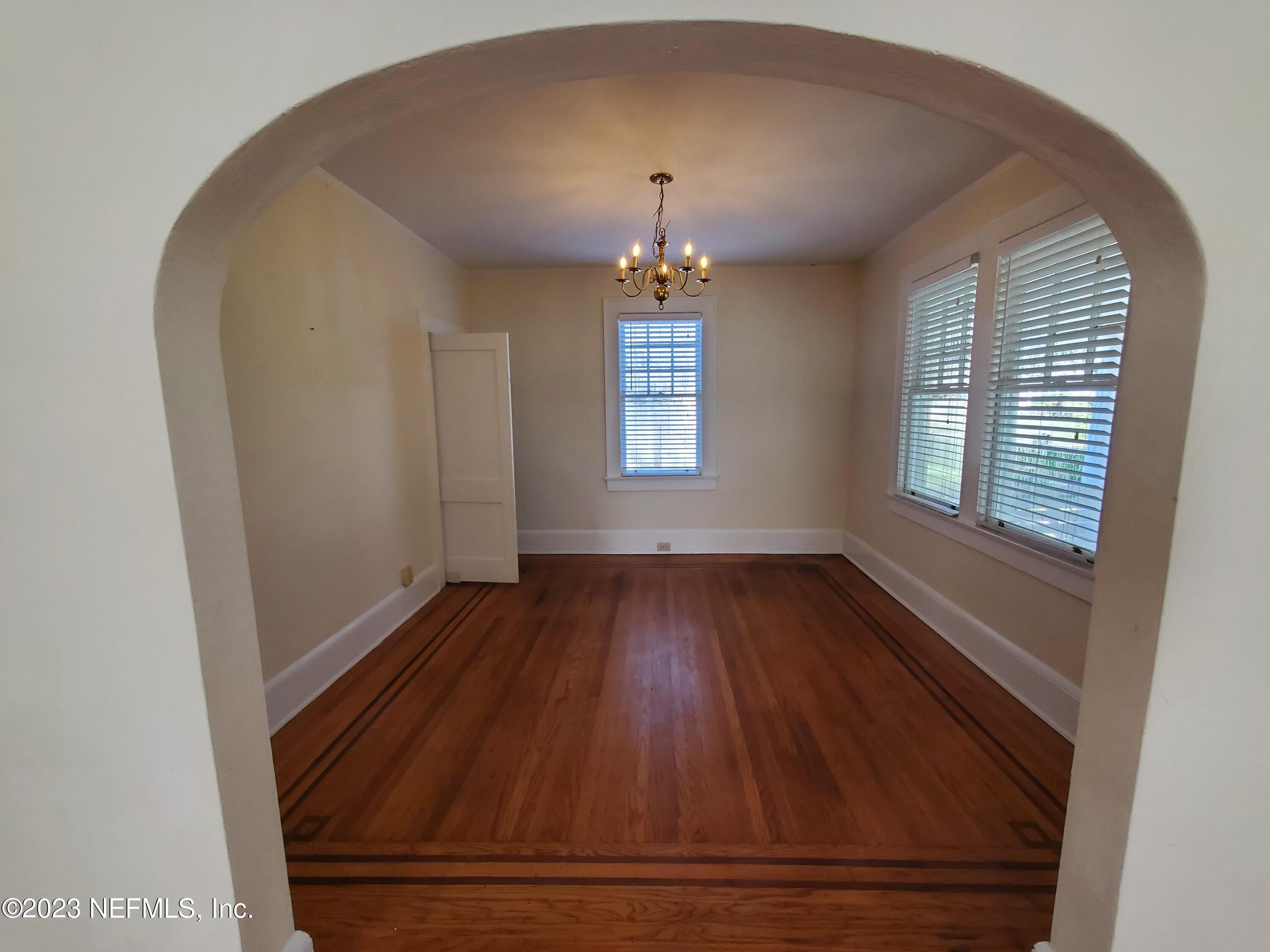 1450 Talbot Avenue Jacksonville, FL 32205 - Photo 9 of 21 an empty room with wooden floor and windows