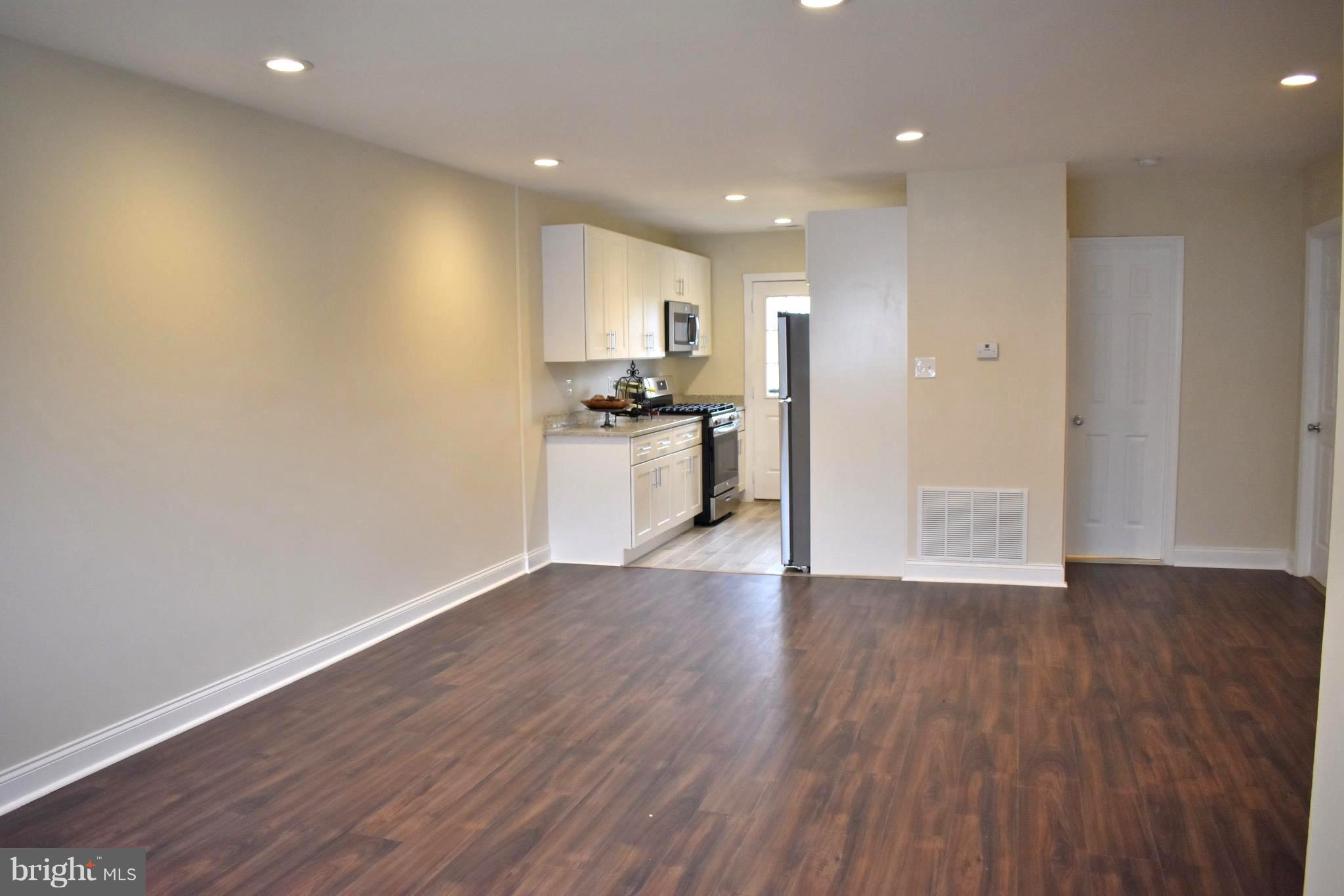 7733 Oxman Road Landover, MD 20785 - Photo 2 of 19 a view of a kitchen with a sink and a stove top oven