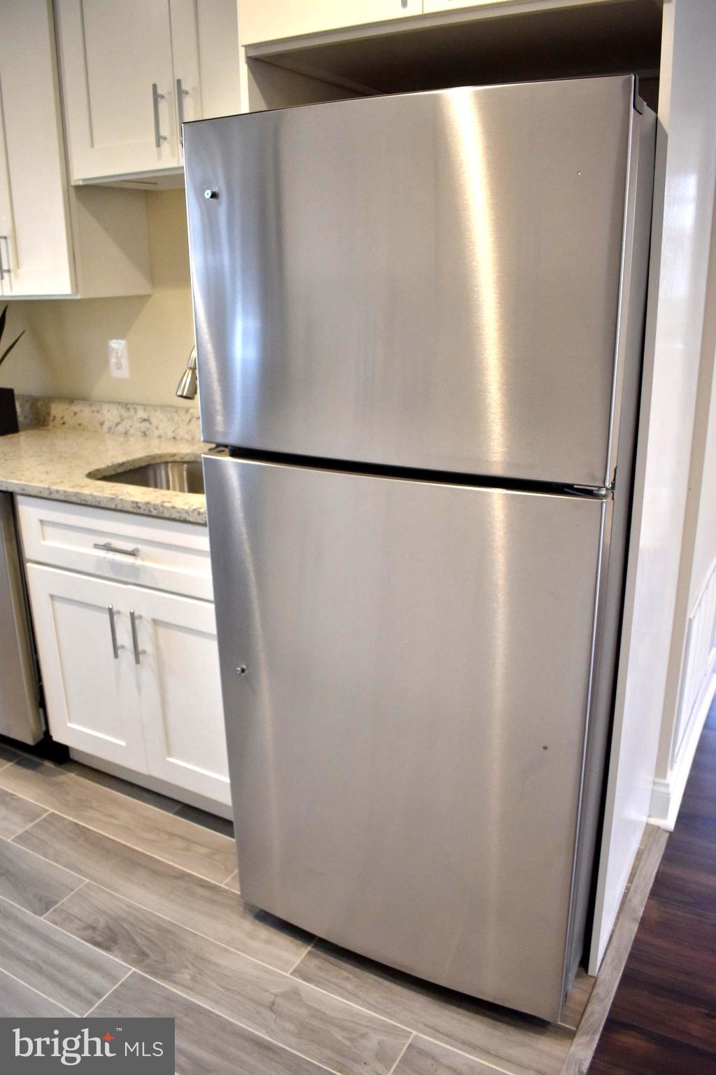 7733 Oxman Road Landover, MD 20785 - Photo 13 of 19 a white refrigerator freezer sitting in a kitchen