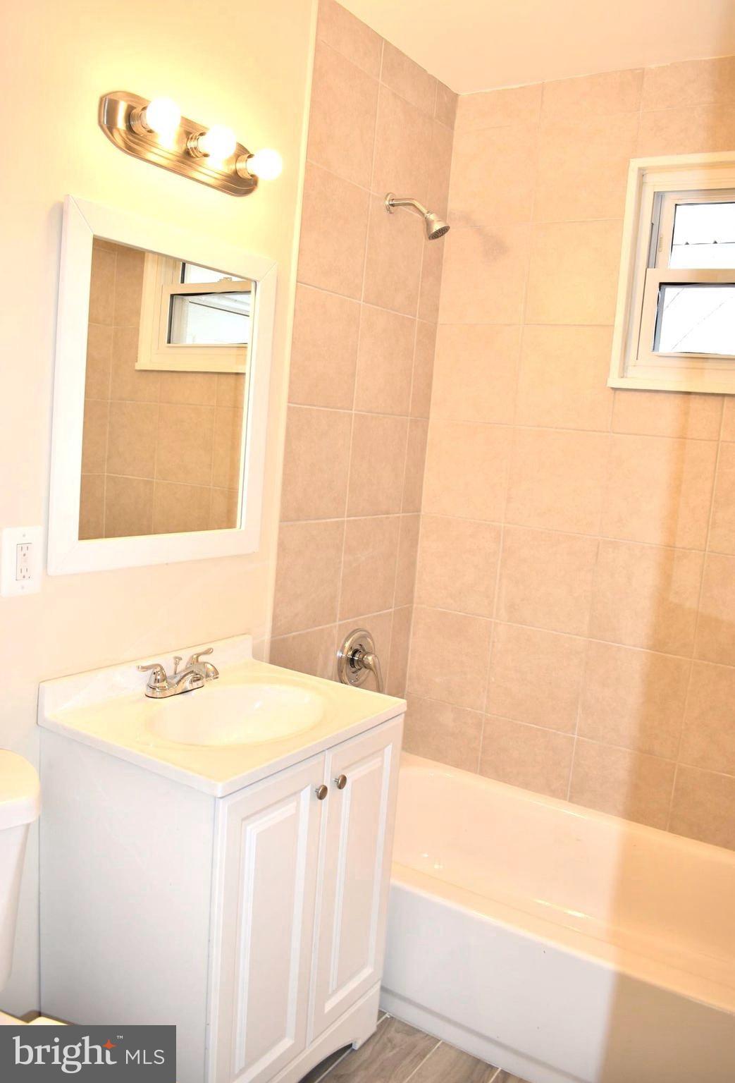 7733 Oxman Road Landover, MD 20785 - Photo 15 of 19 a bathroom with a sink and a mirror